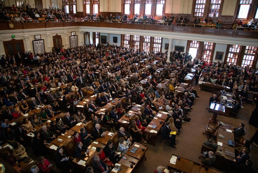 State Representatives and their families sit on the House floor on the opening day of the 88th Legislative Session at the state Capitol in Austin on Jan. 10, 2022.