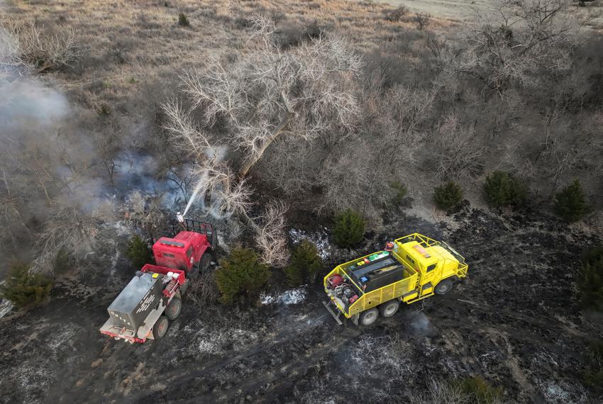 A drone view shows firefighters spraying trees with water after the Smokehouse Creek fire burned through the area in Roberts County, on Feb. 28, 2024.