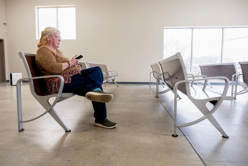 Michelle Smith waits for the next round of Longview Trtansit buses to arrive, on Wednesday March 13, 2024, at Longview's multi-modal transportation center. (Michael Cavazos/Photo)