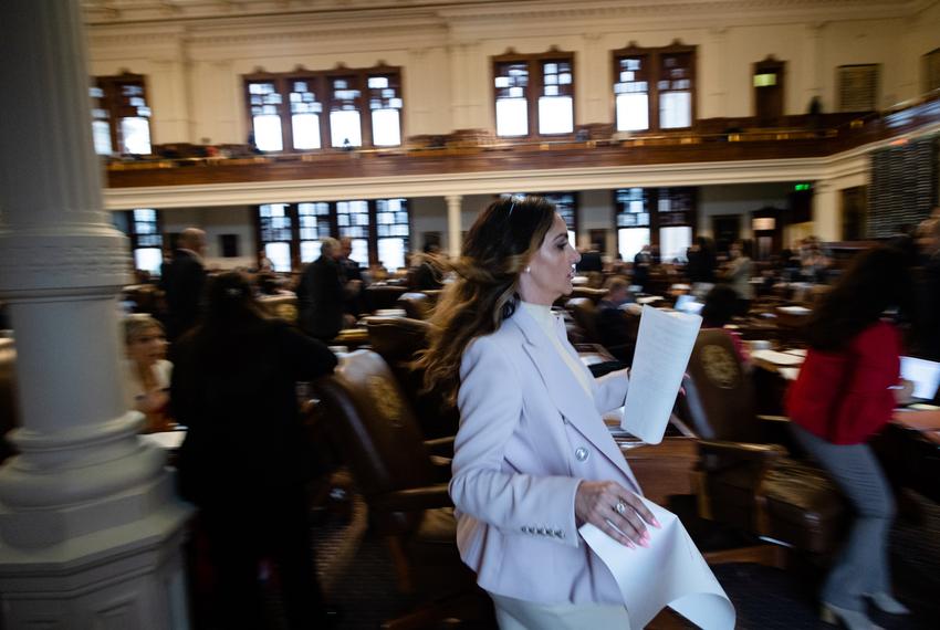 State Rep. Mihaela Plesa, D-Dallas, rushes to the front of the House floor during budget discussions at the state Capitol on April 6, 2023.