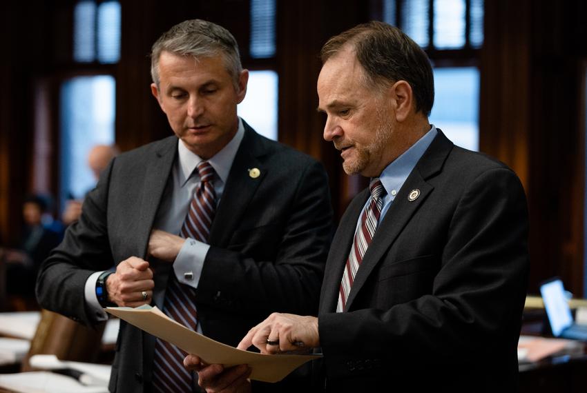 State Rep. Steve Toth, R-The Woodlands, asks Rep. Tom Oliverson, R-Cypress, to sign a bill on the House floor before budget discussions at the state Capitol on April 6, 2023.