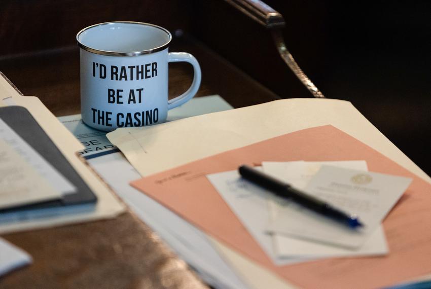 A cup with the message "I'd rather be a the casino" sits on the desk of state Rep. Charlie Geren, R-Fort Worth, on the House floor at the state Capitol on April 6, 2023.