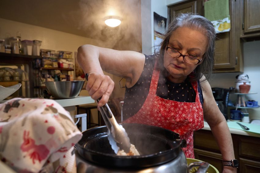 Mary Ann Estrella stirs homemade dog food inside her kitchen in Midland, Texas, on April 20, 2024. Estrella makes her own dog food to save money as living costs increase.