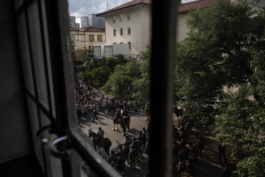 Protestors chant at Texas Department of Public Safety troopers as they begin to push students towards Guadalupe Street from the South Lawn during a demonstration in support of Palestine Wednesday, April 24, 2024, at the University of Texas in Austin.