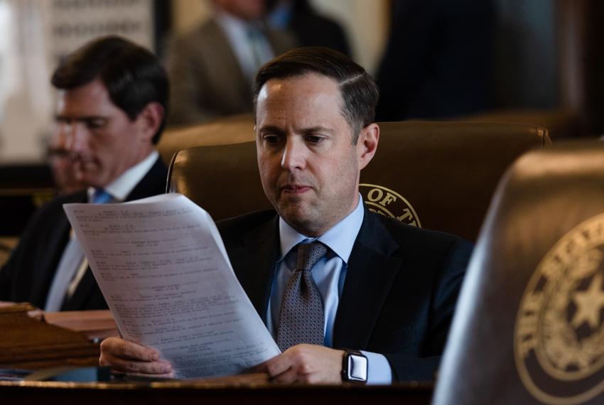 State Rep. Dustin Burrows, R-Lubbock, examines a document at his desk on the House floor during a session at the state Capitol in Austin on April 25, 2023.