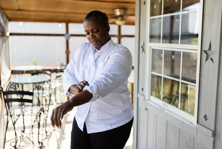 Daniela Roachford, 47, owner of Sugar Grill Caffe, folds her sleeves on April 7, 2024, in Cleveland. Roachford, business owner, and Colony Ridge resident, specializes in Panamanian-inspired dishes.