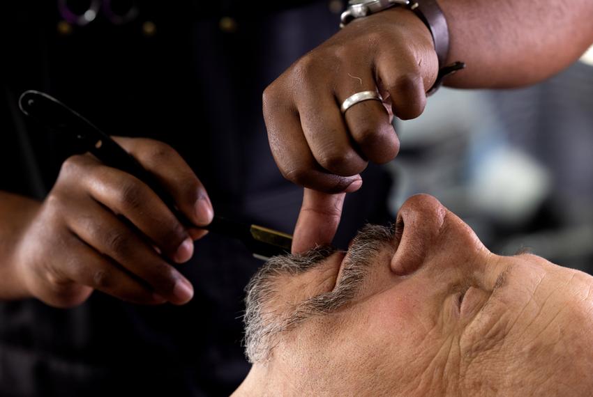 David Thibodeau gets shaved by his barber Johnathan Johnson, 31, at Johnson’s barber shop on March 12, 2024, in Cleveland. Johnson runs his business, Johnathan Bladez Men’s Hair Care, from the garage of his home in the Colony Ridge development.