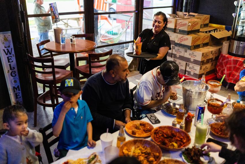 Susana Cazares, 49, Leo’s Beer Barn owner in Cleveland, serves a frozen mango beverage called mangonada, on April 12, 2024, in Cleveland. Cazares, a longtime Colony Ridge resident, fostered her entrepreneurial spirit in the development.