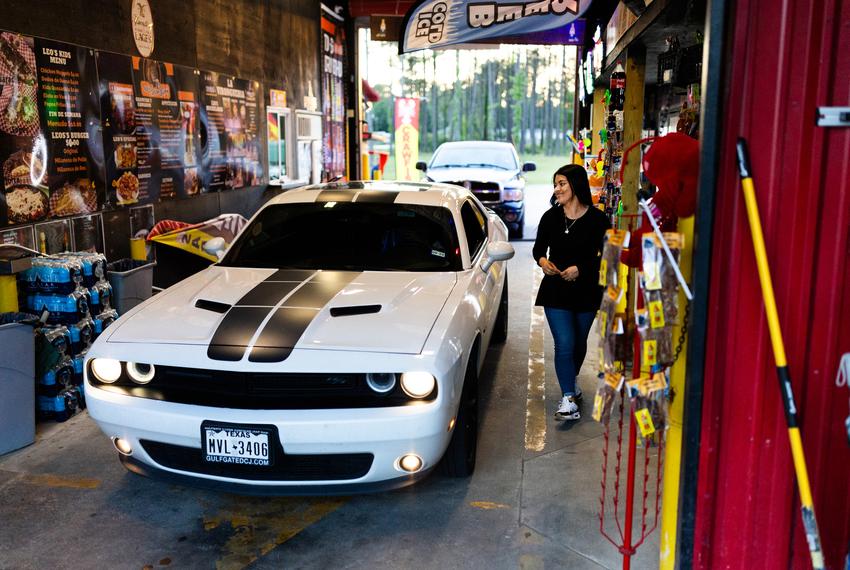 Monica Hernandez, 30, tends to customers looking to purchase anything from a six-pack of Modelos, a case of water or a quick bite to eat while rolling through Leo’s Beer Barn drive-thru on April 12, 2024, in Cleveland.