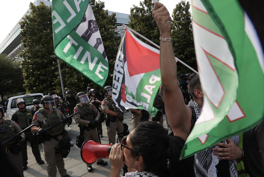 Protesters chant as DPS officers look on at the University of Texas at Dallas on Wednesday, May 1, 2024. Pro-Palestinian demonstrators set up an encampment on the campus before dawn. At about 4 p.m., DPS and other police officers showed up and tore down the encampment and arrested several people.