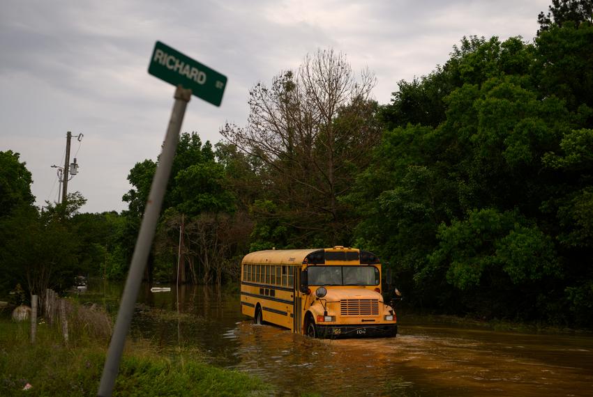 A school bus drives through floodwater to survey the damage as peoples’ homes and possessions are submerged in floodwater following significant rainstorms in Coldspring, Texas, US, on Saturday May 4, 2024.