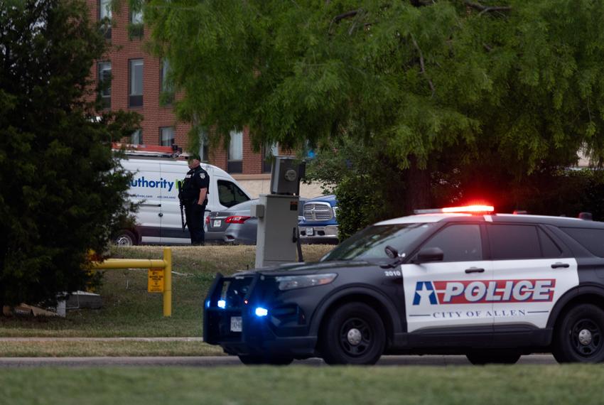 An Allen police officer stands guard  outside Hampton Inn, across from the Allen Premium Outlets after a shooting on May 6, 2023.