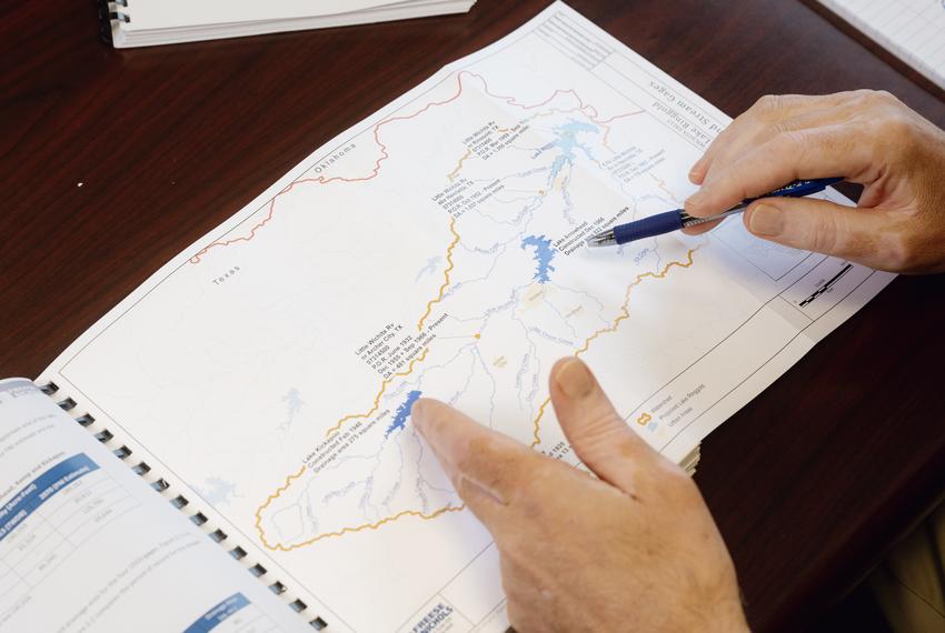 Russell Schreiber, director of Public Works for the city of Wichita Falls, points out two city reservoirs, Lake Kickapoo and Lake Arrowhead, on a Freese and Nichols watershed map inside his office on Monday, May 6, 2024 in Wichita Falls, Texas. The city of Wichita Falls is seeking a permit to construct Lake Ringgold, a reservoir the city says will help with future water needs. Residents and ranchers of Clay County, where Lake Ringgold will be built if approved, claim the project will flood parts of their property.                                                                            