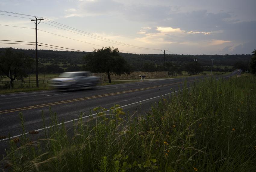 A car drives by Doug Harrison’s property in Comal County nearly halfway between New Braunfels and Bulverde, on June 16, 2023. Harrison’s application for a wastewater treatment plant on his 500-plus-acre plot of land in Comal County stirred controversy as residents have raised environmental concerns.