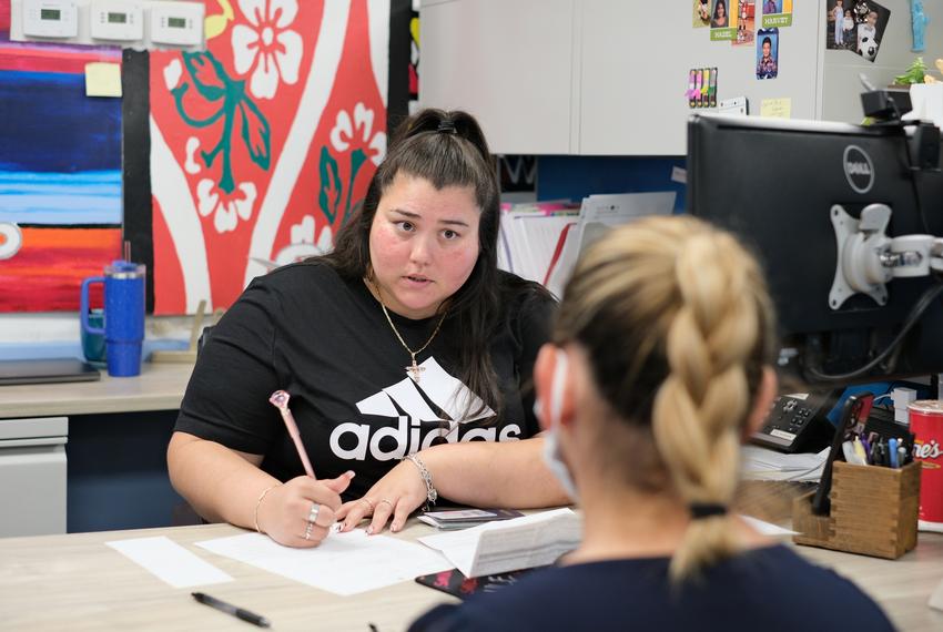 Maricela Delcid of ECHOS listens to a client as she begins the intake process at the E.C.H.O.S office in Houston on Thursday, July 20, 2023.