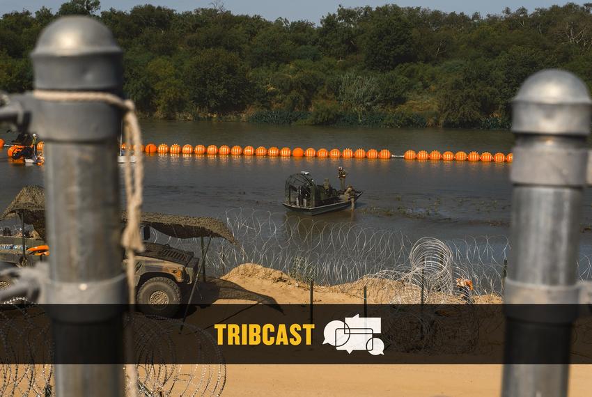 State law enforcement officers stand guard as workers construct a string of buoys which is being deployed to prevent migrants from swimming across the Rio Grande in Eagle Pass on July 14, 2023.