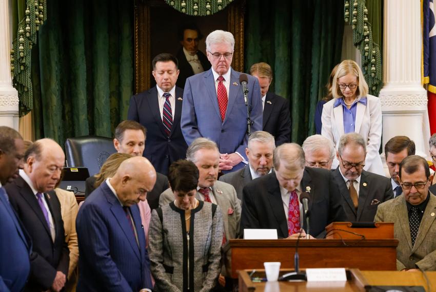 Lt. Gov. Dan Patrick, center, bows his head in prayer as  state Sen. Brian Birdwell, R-Granbury, leads the Senate in prayer during the fifth day of suspended Attorney General Ken Paxton’s impeachment trial in the Senate chamber at the Texas State Capitol in Austin on Monday, Sept. 11, 2023. Brian Birdwell was in the Pentagon when American Airlines flight 77 struck.