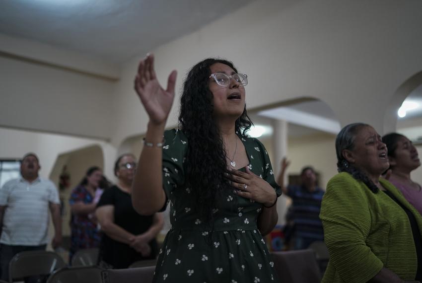 Claudia González sings at the church. 