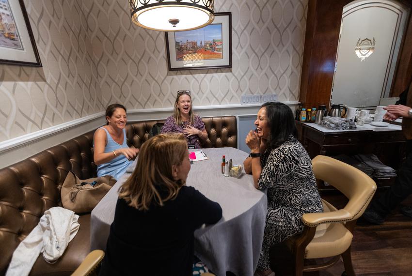 Texas Tribune CEO Sonal Shah, right, speaks with journalist Katie Couric, second from left, at the Austin Club during The Texas Tribune Festival 2023, in Austin, on Sept. 22, 2023.