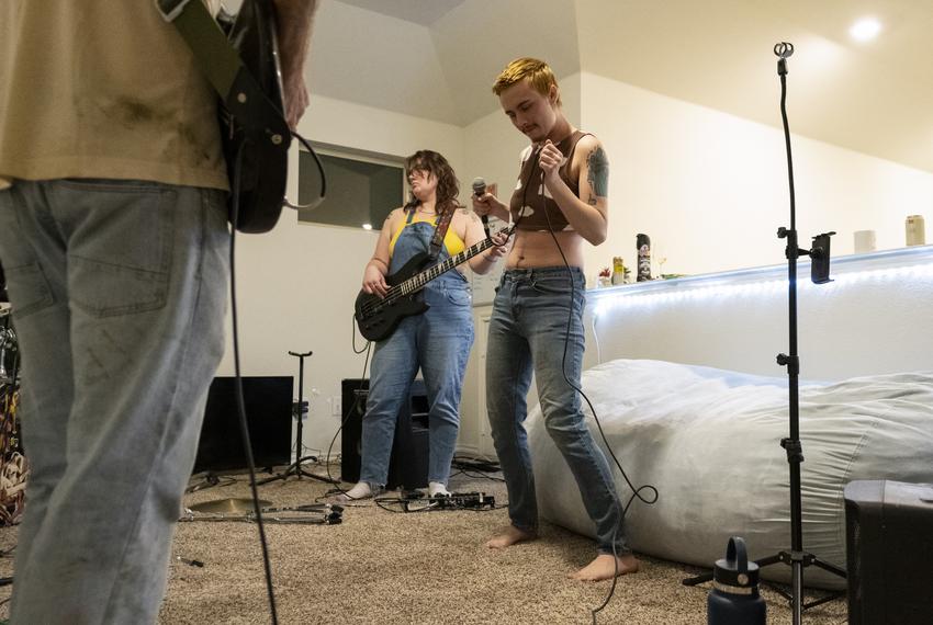 Lead singer of Nip Slip Bowie Brae, right, dances while rehearsing a song Oct. 4, 2023 in Denton. The band Nip Slip will headline Denton’s third annual Trans Pride festival.