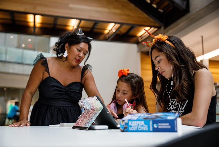 The Harris family works on homeschool curriculum in a study space Oct. 12, 2023 at the Austin Central Library.   