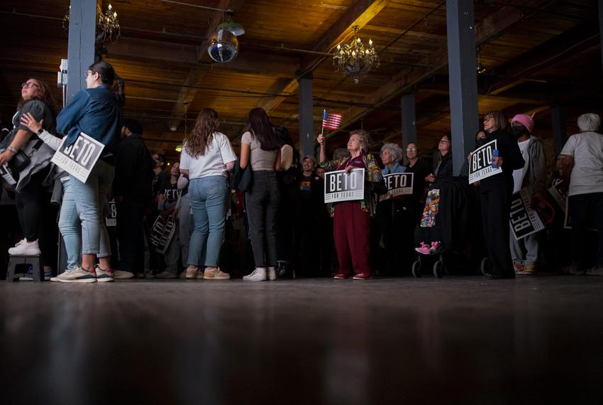 A woman watches the election results and waves a United States flag at the Beto O'Rourke election night headquarters event, on Nov. 8, 2022, in El Paso.