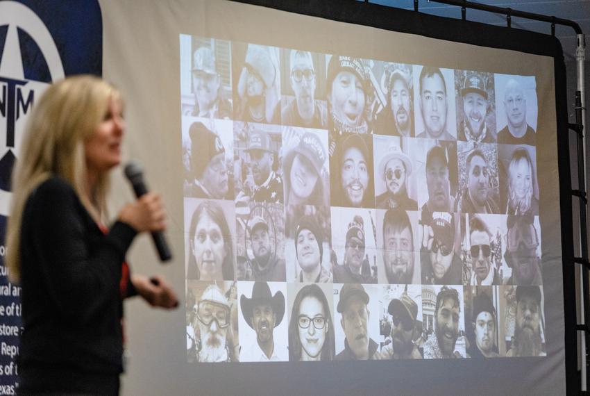 Julie McCarty, the founder of the True Texas Project, speaks to a crowd in front of a slide with images of people criminally charged for their involvement in the Jan. 6 riot, during the Saturday closing event of TEXITCon in Waco, on Nov. 11, 2023.