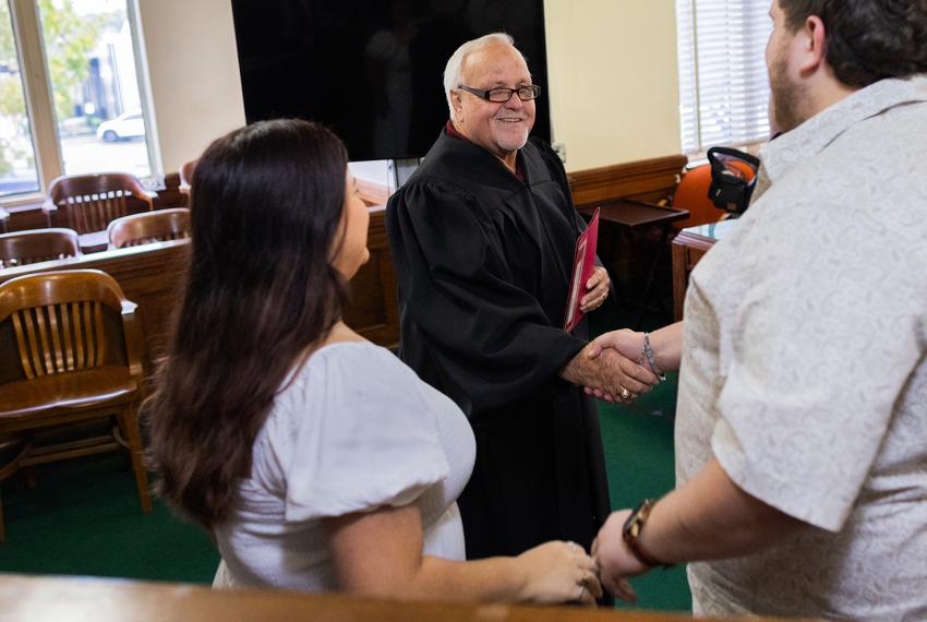 Liberty County Judge Jay Knight, center, congratulates newlyweds after the couple was pronounced husband and wife by Knight at the Liberty County Commissioners Court, on Nov. 13, 2023, in Liberty.