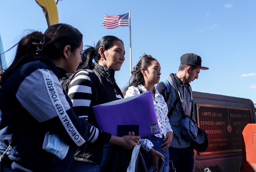 Delmis Jiménez stands on top of the international bridge that divides Ciudad Juárez and El Paso as her family waits for U.S. customs officers to allow them into the United States. Her husband died attempting to reach the U.S. eight months earlier.