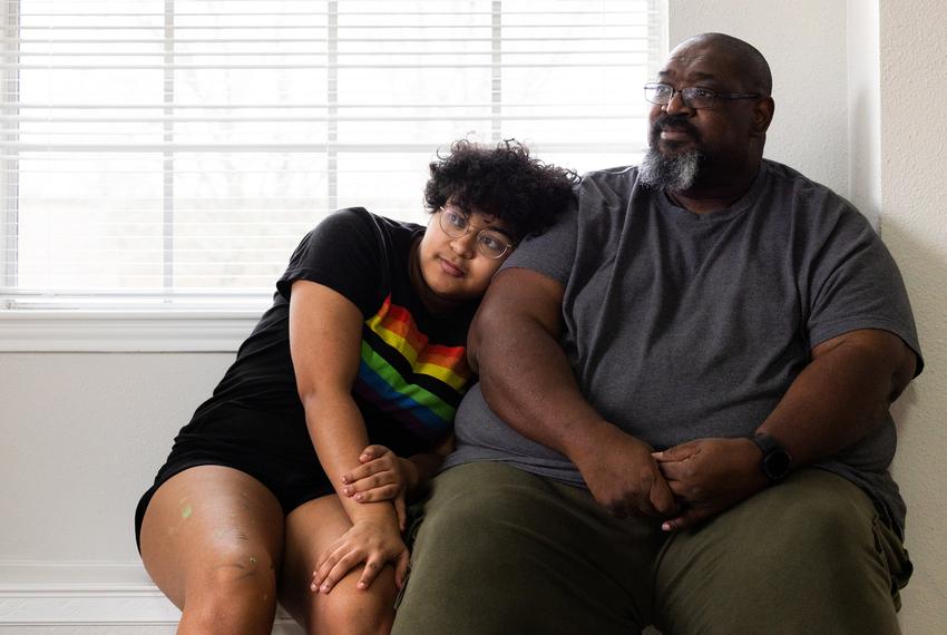 Kadence Carter, 17, leans against his father, William, at their new home in League City on Feb. 16.