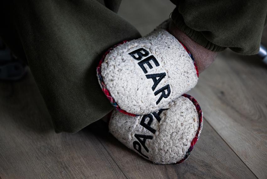 William Carter, a self-described “Papa Bear,” wears embroidered slippers at the League City home he and his son moved into. The father-son duo spent Feb. 16 preparing to move.