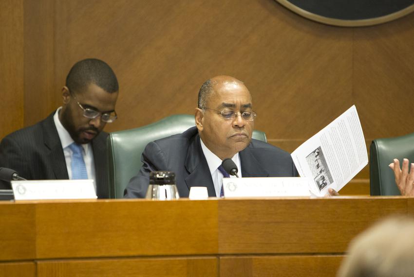 Sen. Rodney Ellis D-Houston reads information during the Senate Committee on State Affairs as they listen to testimony relating to guns on campus and open carry on February 12th, 2015