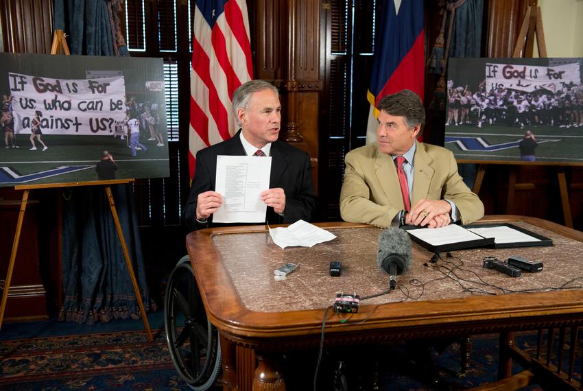 Texas Attorney General Greg Abbott, l, and Governor Rick Perry, r, defend public acknowledgments of religion showing support for the Texas Religious Viewpoints Anti-Discrimination act. The case involves the Kountze ISD and cheerleaders' display of a religious message in a football banner.