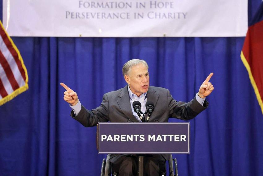 Gov. Greg Abbott speaks to students, parents and staff at Nolan Catholic High School in Fort Worth while trying to build support for school vouchers legislation on April 19, 2023.