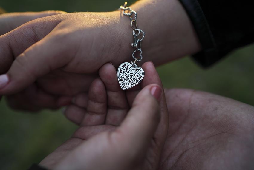 Adamalis Vigil, 34, holds a bracelet that she and her husband got for their daughter Adelyn Vigil, 13, who is a transgender girl, as they pose for a photo in the Rio Grande Valley on Sunday, February 27, 2022. Adamalis says that Governor Abbott’s order for the Texas Department of Family and Protective Services (DFPS) to investigate parents that provide gender-affirming care to their kids , “Hasn’t made me doubt myself as a parent because I know what it’s right for my child.” Adelyn says that, “The thought of me being separated makes me cry and to think that my mom could go to jail for it and not being able to see her anymore.”
Verónica G. Cárdenas for The Texas Tribune