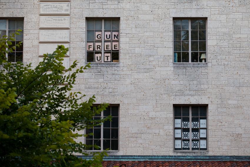 "Gun Free UT" signs hang from office windows at the University of Texas at Austin on July 29, 2017, nearly a year after the state's campus carry law went into effect.