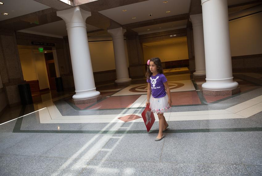 Libby Gonzales, a 7-year-old transgender girl, walks through the Capitol before testifying against SB 3 and SB 91, the "bathroom bills," before the Senate State Affairs Committee with her family on July 21, 2017.