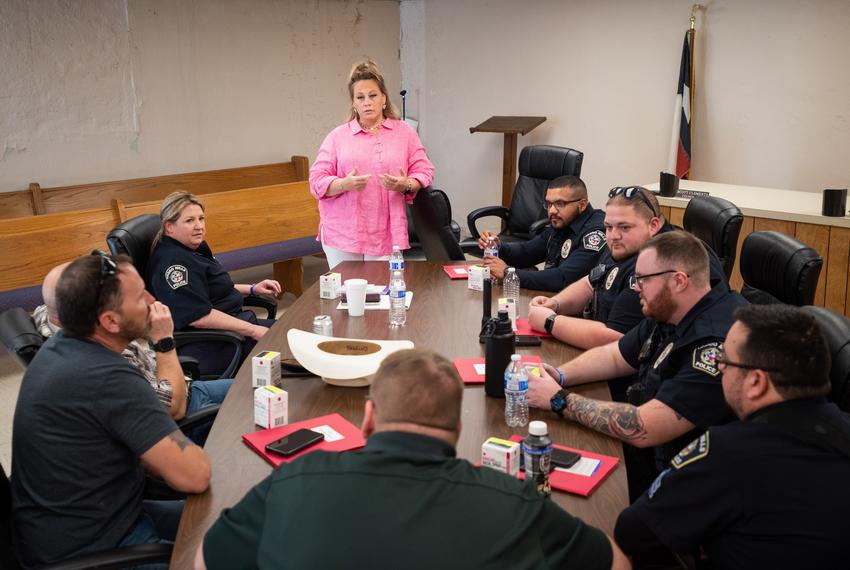 Callie Crow, the founder of Drew's 27 Chains, conducts a Narcan training session with officers from the Caddo Mills Police Department, on March 31, 2022. Callie started her nonprofit to educate law enforcement departments about the opioid crisis after her son, Drew Crow, died from an opioid overdose.