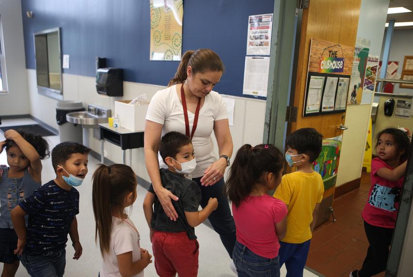 Cardenas watches over her students and receives hugs as students wait in the lunch line on April 21, 2022.