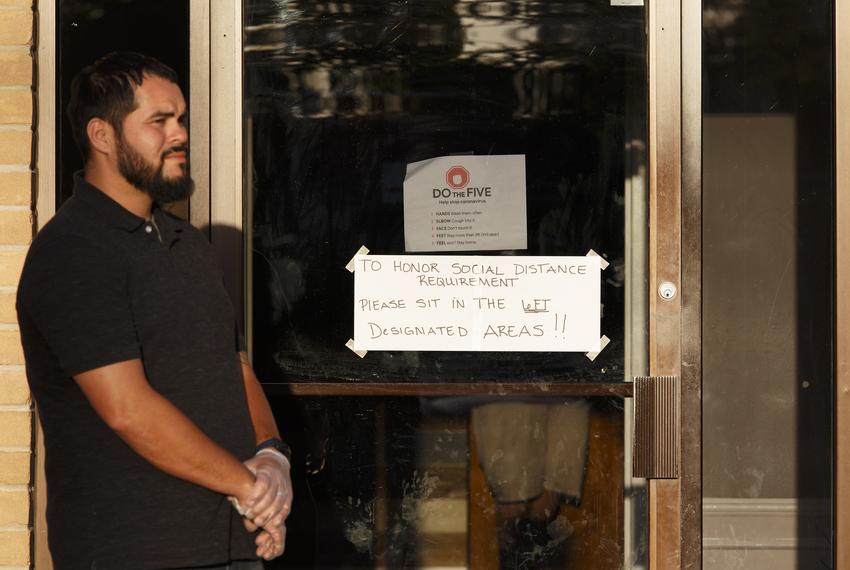 Worshippers arrive for a church service at City on a Hill Church  in Houston. Rubber gloves were handed out as people arrived and a sign on the door asked people to sit six feet apart as a precaution. April 1, 2020.