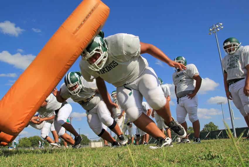 In Brownsville, offensive linemen for Pace High School's football team hit a sled during a Sept. 11 practice.