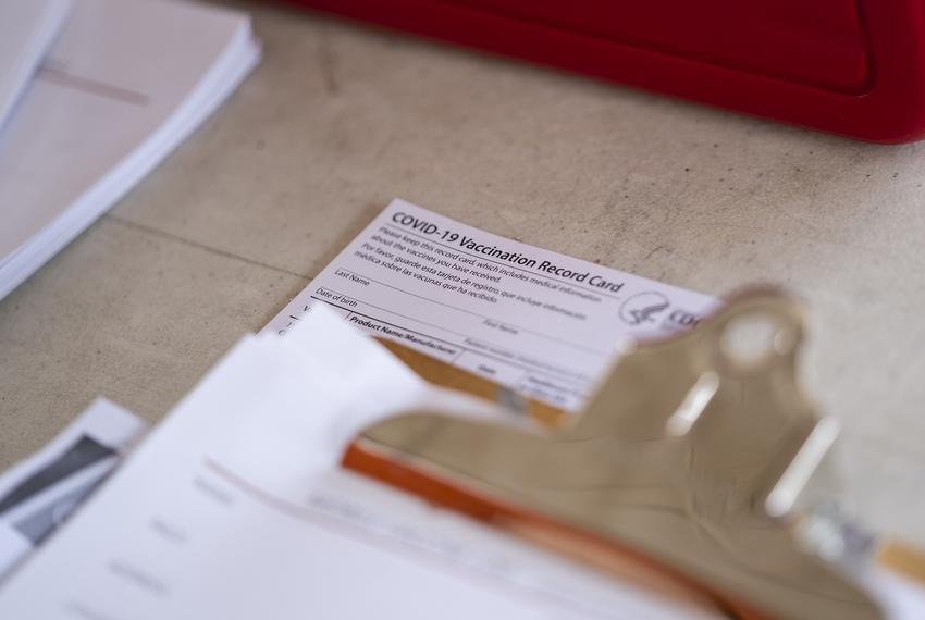 A COVID-19 Vaccination Record Card sits on a table at a vaccine clinic held in partnership between the Central Texas Food Bank and University of Texas in Austin on July 21, 2021.