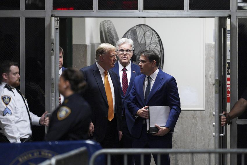 Texas Lt. Gov. Dan Patrick, center, accompanies former U.S. President Donald Trump as he speaks to his attorney Todd Blanch at the Manhattan Criminal Court where he is on trial for hush money payments in New York City on May 21, 2024.