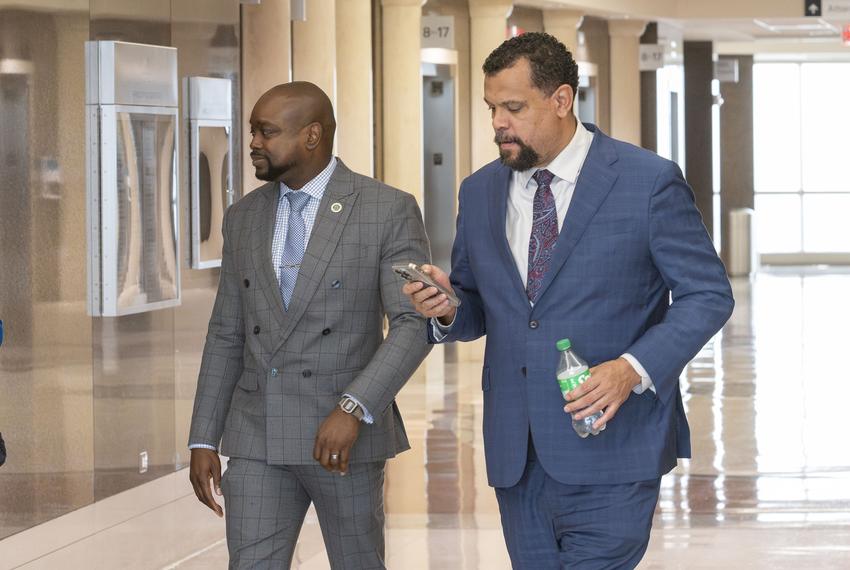 180th District Court Court Judge DaSean Jones, left, enters the the courtroom with his attorney at the Harris County Civil Courthouse in Houston on April 1, 2024.