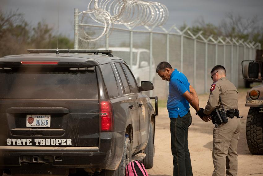 A Texas Department of Public Safety official arrests Nerio, a Venezuelan migrant, near the U.S. and Mexico border in Del Rio on July 23, 2021.