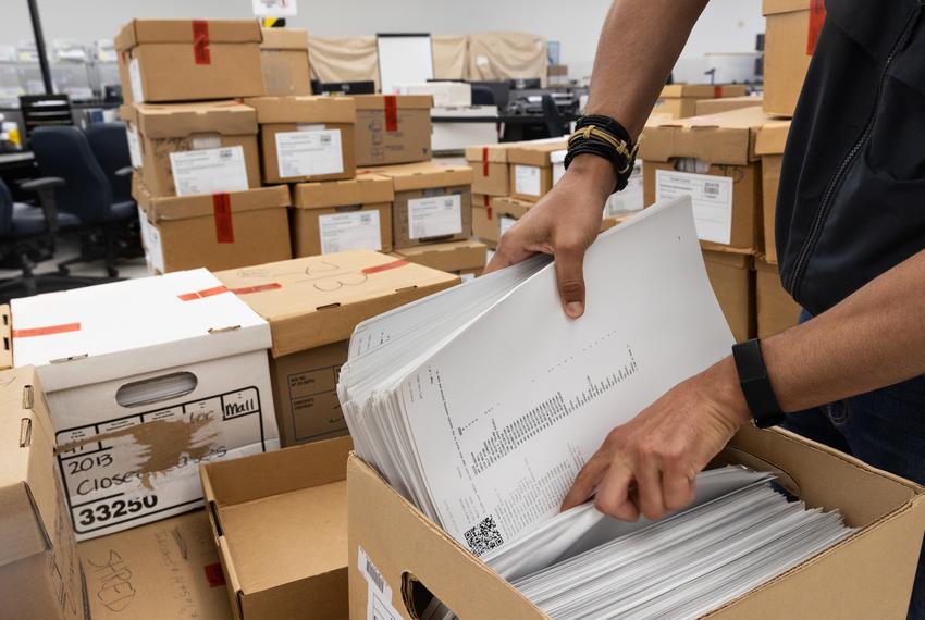 Election Administrator Heider Garcia goes through boxes of ballots from the 2020 GOP primary elections that will be recounted by an election integrity group at the Tarrant County Elections Administration building in Fort Worth on July 22, 2022. Ballots become public records after 22 months, granting this group access to review the votes from this election, and eventually, the general.