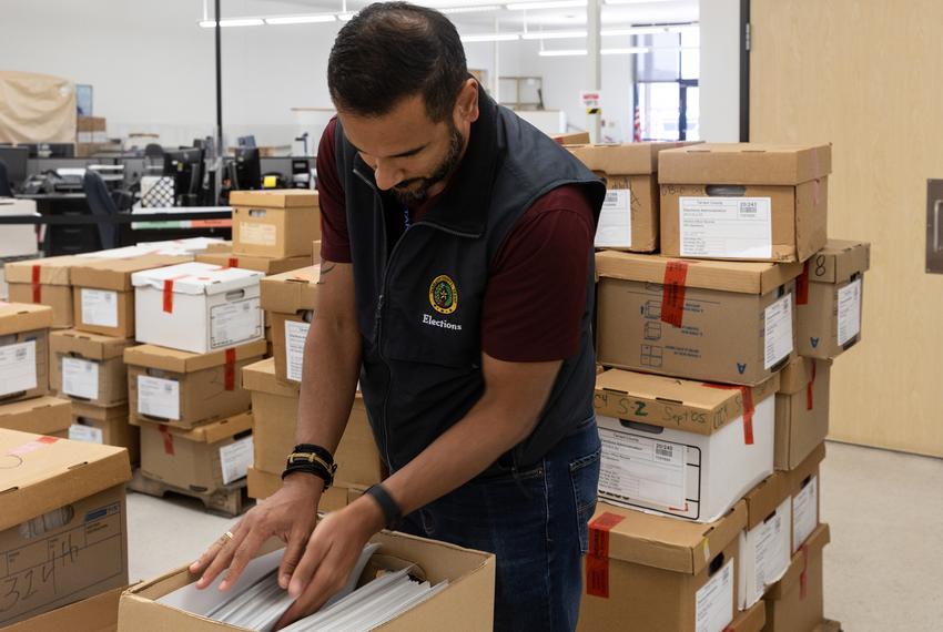 Elections Administrator Heider Garcia goes through boxes of ballots from the 2020 GOP primary elections that will be recounted by an election integrity group at the Tarrant County Elections Administration building in Fort Worth, TX on July 22, 2022. Ballots become public records after 22 months, granting this group access to review the votes from this election, and eventually, the general.