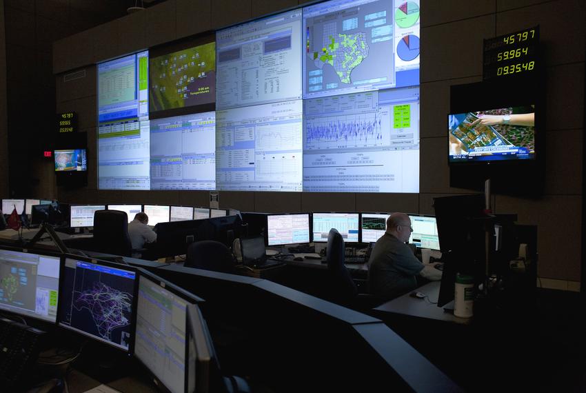 Four reliability coordinators monitor the state power grid during a tour of the Electric Reliability Council of Texas (ERCOT) command center in Taylor on August 14, 2012.