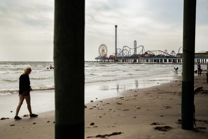 MacKenzie Edmundson walks along the shore of Galveston's coast on April 12, 2021.