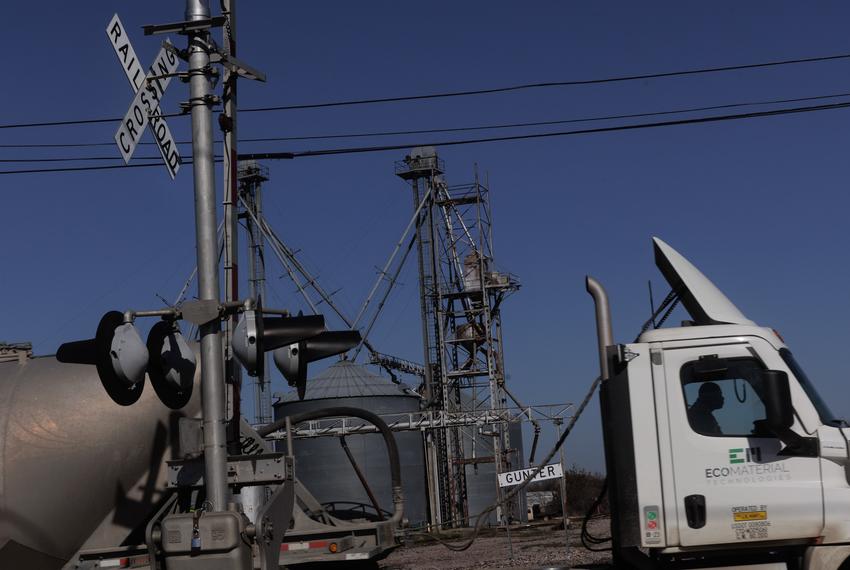 A cement trucks drive over a railroad that runs through the heart of Gunter, TX on January 11, 2024.